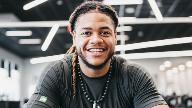 Chase Young smiles for a photo shoot.